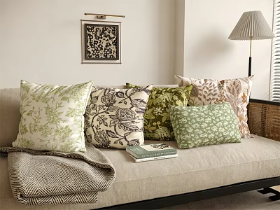 Throw Pillows With Floral And Geometric Patterns On Beige Sofa With Lamp And Wall Art 3d model