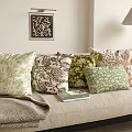 Throw Pillows With Floral And Geometric Patterns On Beige Sofa With Lamp And Wall Art