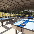 Glass Enclosed Lounge Area With Open Design Tables And Comfortable Chairs