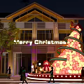 Giant Christmas Tree Balloon Decoration With Gift Boxes And Merry Christmas Sign Outside Building At Night