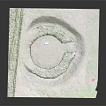 Circular Stone Garden Ornament with Grass Covered Edges and Central Square Slab