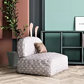 Modern Single Sofa with Grey Patterned Fabric Brown Cushion Green Plant and Herringbone Wooden Floor