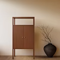Wooden Decorative Cabinet With Metal Handles And Black Vase Branches Against Beige Wall