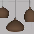Three Metallic Pendant Lights with Shiny Dome Shapes Hanging in Modern Interior