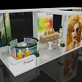 Modern Exhibition Booth With Curved Display Areas Seating Green Plants And Large Model Posters