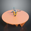 Game Movie Robot Character Featuring Yellow Black Antenna Wing Like Structures On Round Orange Table