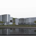 Modern White Multi Storey Office Building Near Riverside With Green Space Trees And Water Reflection