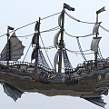 Floating Vintage Wooden Sailing Ship With Multiple Gray Sails And Ornate Hull Structure
