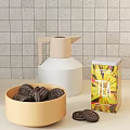 Beige Water Jug Colorful Tea Tins and Bowls with Candies Chocolate Bars on Kitchen Counter