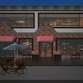 Charming Commercial Street With Red Brick Buildings Red Awnings Outdoor Seating And Wooden Deck