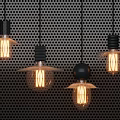 Vintage Pendant Lights With Illuminated Edison Bulbs And Minimalist Design On Black Perforated Background