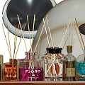 Perfume Cosmetics Collection On Metal Tray With Aromatic Bottles Reed Diffusers Candles And White Rose