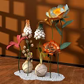 Colorful Floral Display With Orange White Pink Flowers In Spherical Vases On White Pebble Base