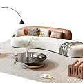 Modern Curved Sofa And Round Coffee Table Set With Brown Pillows And Striped Rug