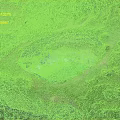 Natural Scenic Giant Blue Lagoon Surrounded by Lush Green Vegetation and Cliffside Grassland Path