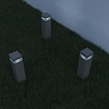Three Pillar Shaped Outdoor Lights With Square Illuminated Tops On Grass Near Gray Wall