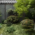 Traditional Japanese Garden Landscape With Stone Wall Tile Roof And Lush Green Plants