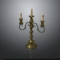 Brass Candelabra With Three Candles And Ornate Design On Black Background