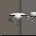 Modern Wall Lamps With White Shades And Metal Brackets Mounted On Light Colored Wall