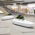 White Boat Shaped Public Chairs With Green Plants And Red Flowers In Shopping Mall
