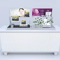 White Skincare Display Counter With Advertising Screens And Green Plants