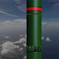 Green Missile Flying With Rocket Exhaust Over Ocean And Land Under Cloudy Sky