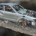 Wrecked Silver Car With Broken Body Exposed Engine And Debris Around 3d model