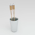 Two Decorative Wicker Covered Wooden Sticks Standing Vertically in White Ceramic Cup