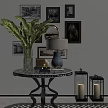 Interior Decor Setup With Round Table Vase Green Plants Lamp Lantern Candlesticks And Wall Framed Art