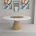 Modern Dining Room Featuring Round White Table With Wooden Pleated Leg And Framed Wall Art