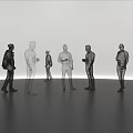 Human Shaped Art Installation With Black And White Standing Figures On Smooth Gray Floor