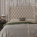Elegant Double Bed With Beige Tufted Headboard White Bedspread And Green Blanket