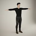 Man In Black Long Sleeve Top And Black Pants With Arms Outstretched Against Light Background