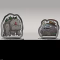 Two Cartoon Monster Figurines On White Speckled Bases With Green Leaf Decor And Hat Accessory