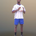 Man in white Adidas T-shirt and blue shorts holding a soccer ball