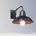 Black Metal Wall Lamp With Curved Arm And Illuminated Bulb Mounted On White Wall