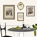 Framed Artworks On Wall With White Round Table Green Apples Books And Black Chair