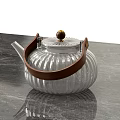 Elegant Silver Teapot with Wooden Handle and Ribbed Design on Marble Countertop