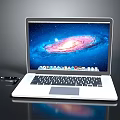 Modern White Laptop With Galaxy Display On Sleek Black Surface And Accessories
