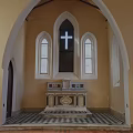 Traditional Church Building With Steeple Tower Brown Exterior Gray Roof Round Window And Arched Doorway