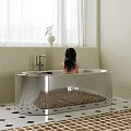 Freestanding White Bathtub Interior with Child and Chrome Faucet Near Window Curtain and Vase