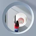 Woman Viewing Mirror In Circular Structure Of Modern Sales Office With White And Pink Walls