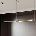 Modern Kitchen Interior With Linear Metal Pendant Lights And Dark Cabinetry