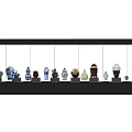 Ceramic Vessels With Various Colors And Different Shapes Arranged On Black Shelf