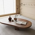 Oval Wooden Coffee Table with Open Book Glass Vase with Branches and Teapot by Window