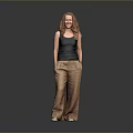 Red Haired Woman Wearing Black Tank Top Brown Pants Standing On Reflective Floor Gray Background