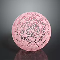 Decorative Pink Hollow Sphere Featuring Intricate Geometric Patterns And Reflective Surface