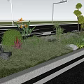 Colorful Roadside Flower Bed Featuring Various Flowers Plants Trees And Red Brick Buildings
