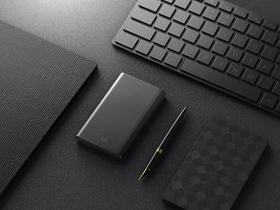 Black Computer Accessories Setup With Keyboard Power Bank Pen And Checkered Notebook On Desktop 3d model