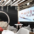 Modern Exhibition Booth Design With Tables Chairs Display Area And Brand Signage